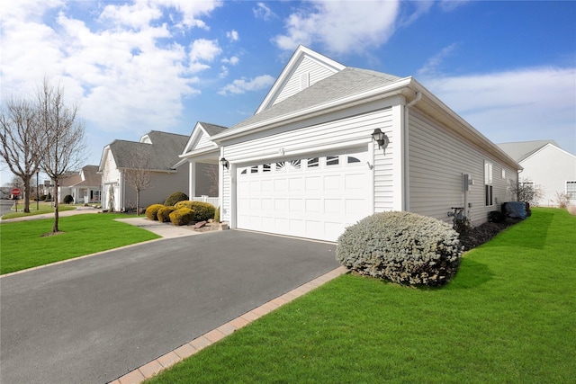 view of front facade with a garage, a residential view, a front lawn, and aphalt driveway