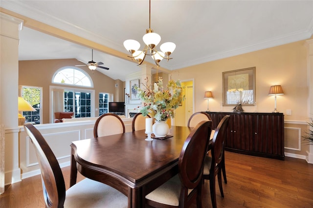 dining room featuring vaulted ceiling, ceiling fan with notable chandelier, wood finished floors, and crown molding