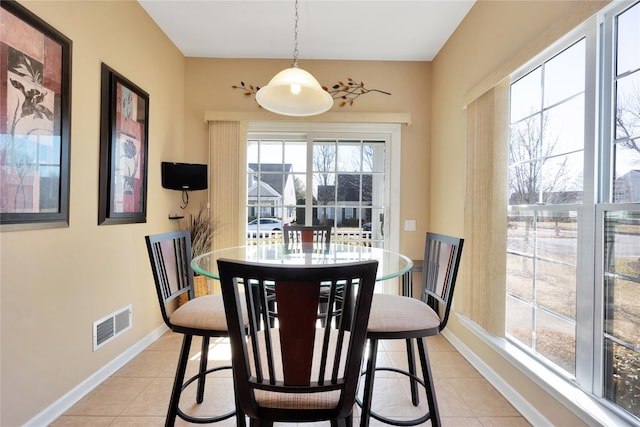 dining space featuring light tile patterned floors, baseboards, and visible vents