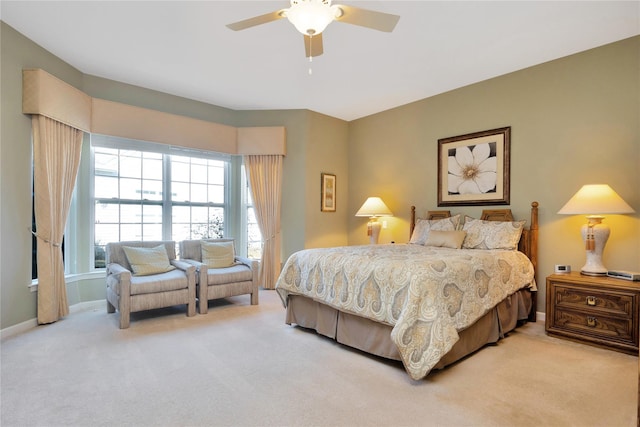 bedroom featuring baseboards, a ceiling fan, and light colored carpet