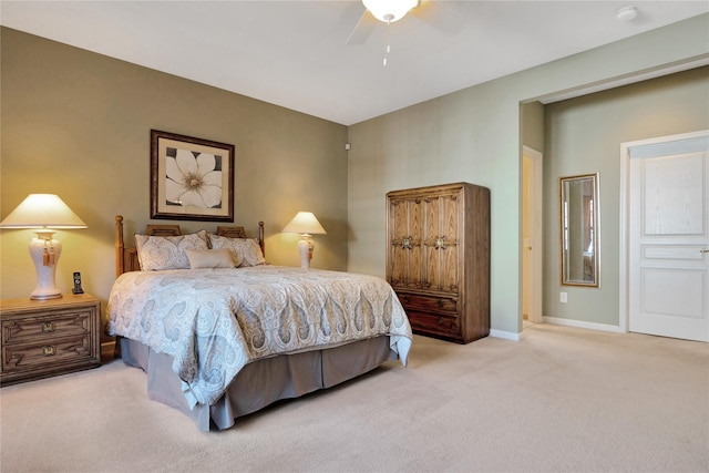 carpeted bedroom with a ceiling fan and baseboards