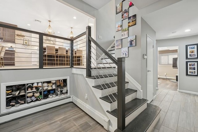 stairs featuring recessed lighting, baseboards, baseboard heating, and wood tiled floor