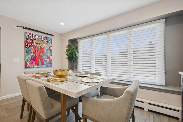 dining space with recessed lighting, light wood-style flooring, baseboards, and a baseboard radiator