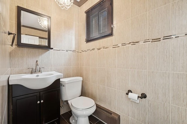 half bath featuring toilet, tile walls, and vanity