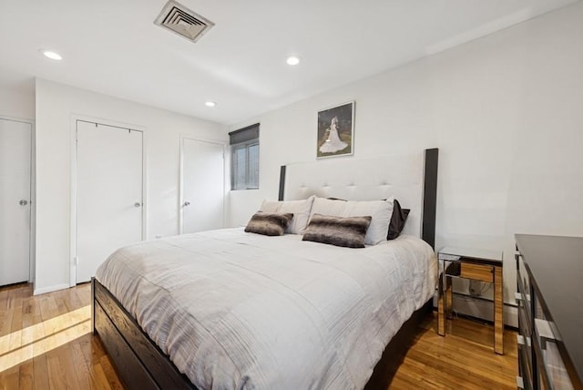 bedroom with recessed lighting, visible vents, and hardwood / wood-style floors