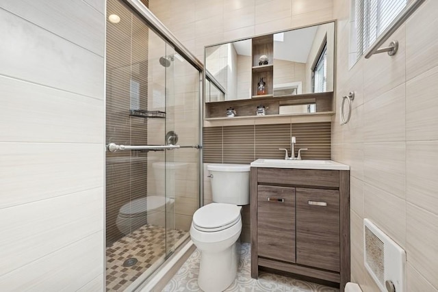 bathroom featuring heating unit, toilet, a stall shower, and tile walls