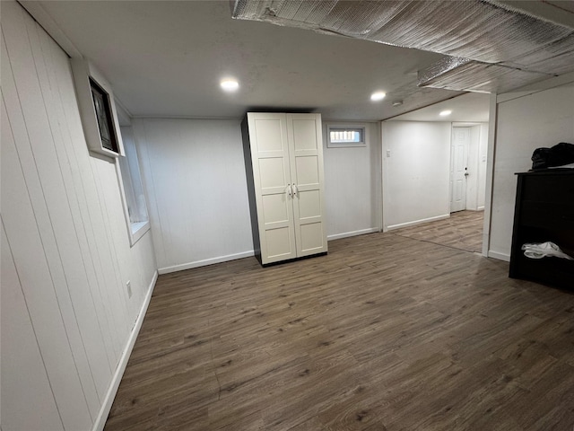 finished basement with dark wood finished floors, recessed lighting, and baseboards