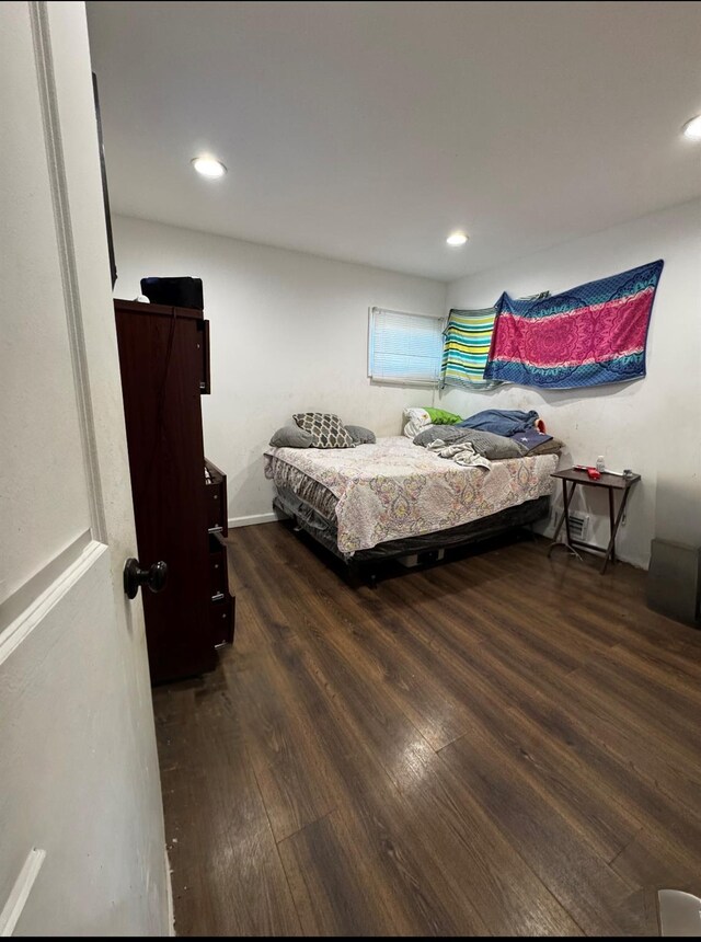 bedroom featuring recessed lighting and wood finished floors