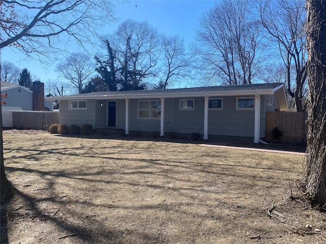 ranch-style home with fence