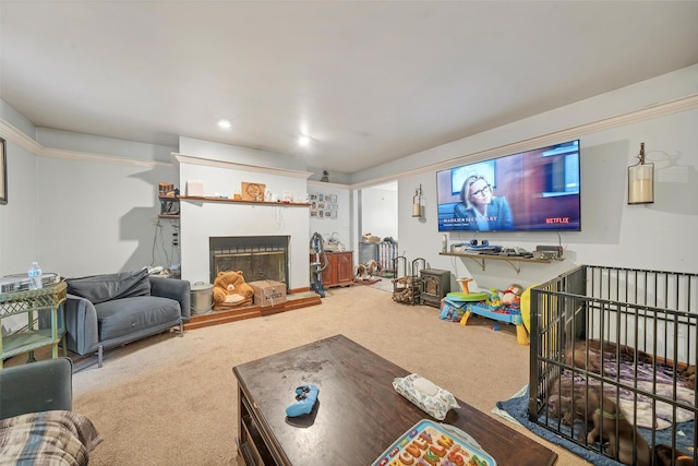 living room featuring recessed lighting, a fireplace with raised hearth, and carpet flooring