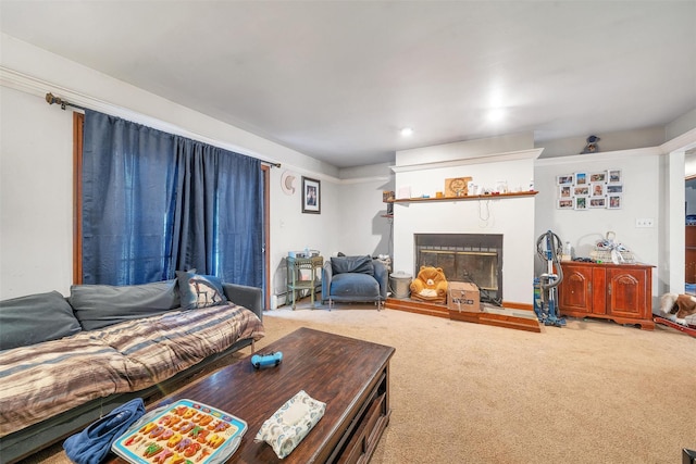 carpeted living area with a fireplace and a baseboard radiator