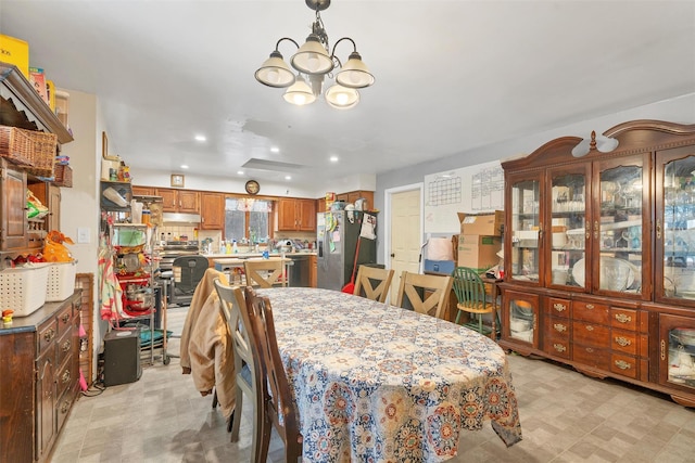 dining area featuring a chandelier, recessed lighting, and light floors