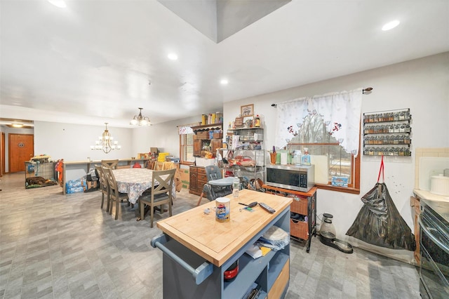 dining room featuring recessed lighting, tile patterned floors, and an inviting chandelier