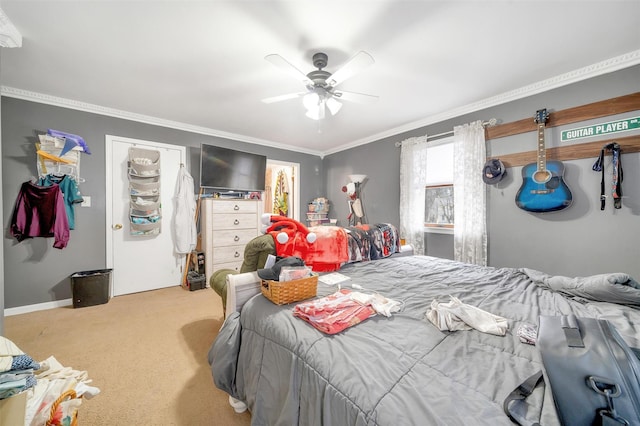 bedroom with ceiling fan, baseboards, carpet flooring, and crown molding