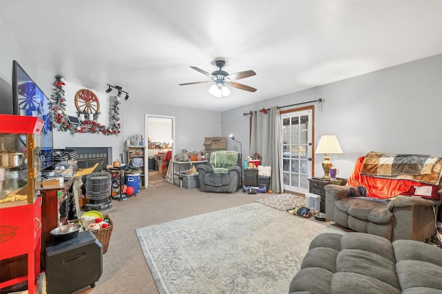 living room featuring a ceiling fan and carpet flooring