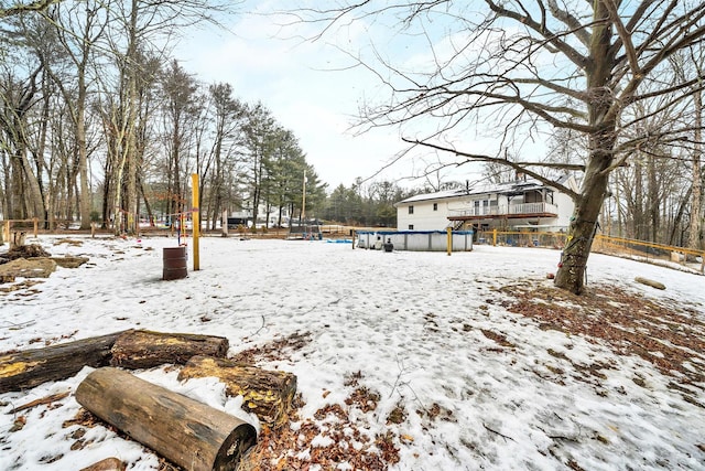 snowy yard featuring an outdoor pool