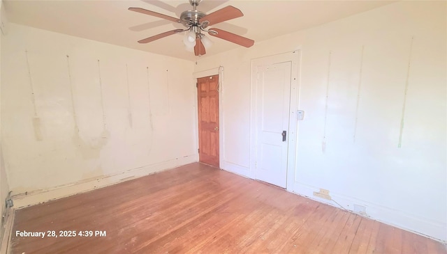 unfurnished room featuring wood finished floors and a ceiling fan