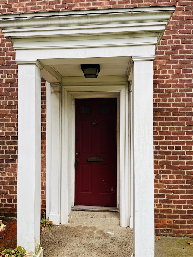 property entrance with brick siding