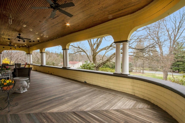 wooden terrace featuring ceiling fan