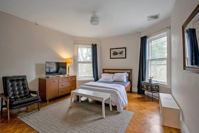 bedroom featuring radiator heating unit, visible vents, baseboards, and ornamental molding