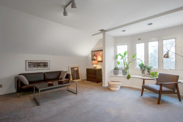 sitting room with baseboards, track lighting, visible vents, lofted ceiling, and carpet