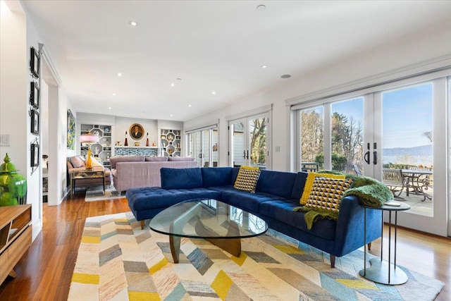 living area featuring recessed lighting, french doors, and light wood finished floors