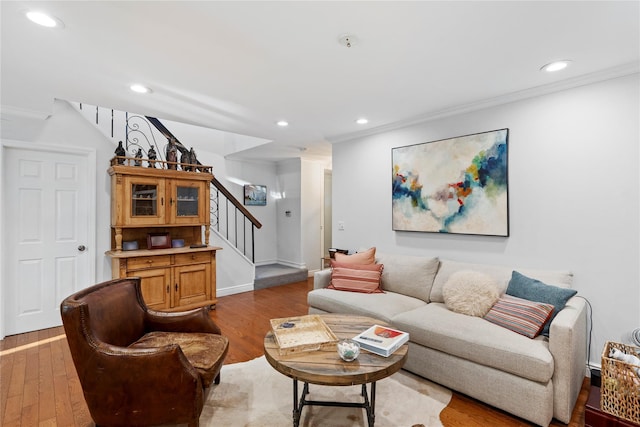 living area featuring crown molding, recessed lighting, wood finished floors, baseboards, and stairs