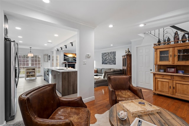 interior space with ornamental molding, light wood-type flooring, and recessed lighting