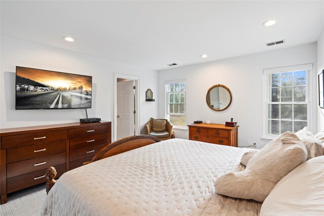 carpeted bedroom featuring recessed lighting and visible vents