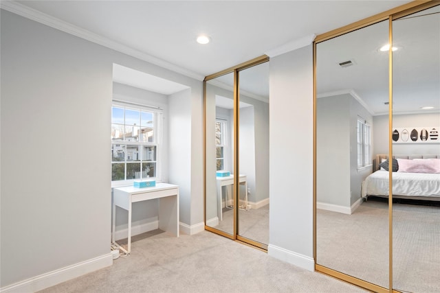 carpeted bedroom with multiple closets, visible vents, ornamental molding, and baseboards