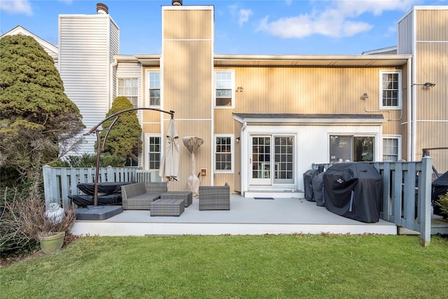 rear view of house with a patio area, a lawn, and an outdoor hangout area