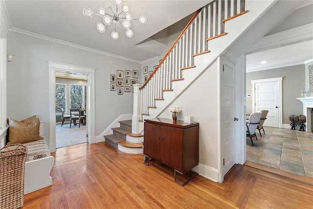 stairway featuring an inviting chandelier, crown molding, and baseboards