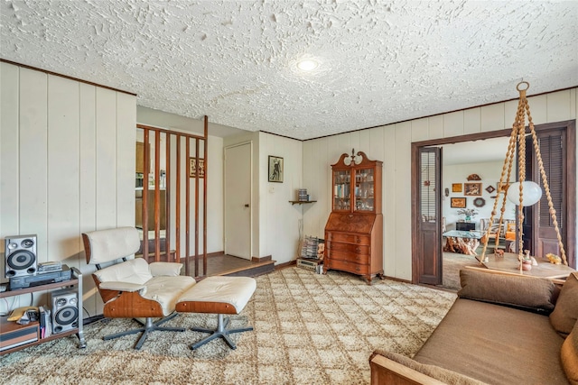 living room with baseboards and a textured ceiling