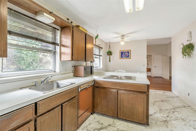 kitchen featuring dishwashing machine, electric stovetop, marble finish floor, and a sink