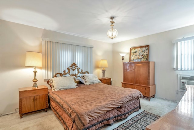 bedroom featuring light carpet and a chandelier