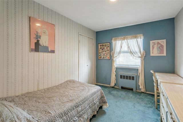 carpeted bedroom featuring a closet, radiator, wallpapered walls, and baseboards