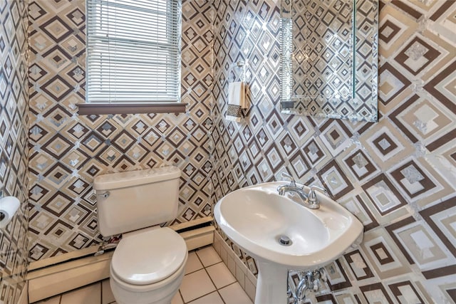 bathroom with tile patterned floors, toilet, and a sink