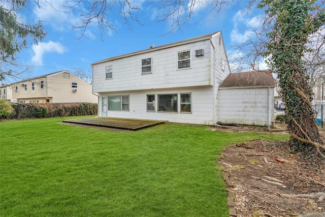 back of property featuring a yard and a wooden deck