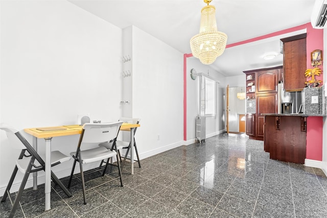 dining space featuring a wall mounted AC, granite finish floor, an inviting chandelier, and baseboards