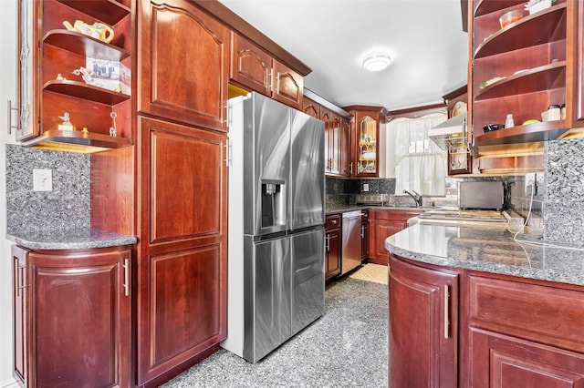 kitchen featuring reddish brown cabinets, open shelves, backsplash, appliances with stainless steel finishes, and wall chimney exhaust hood