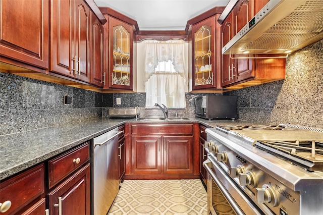 kitchen with stainless steel appliances, a sink, under cabinet range hood, and dark brown cabinets