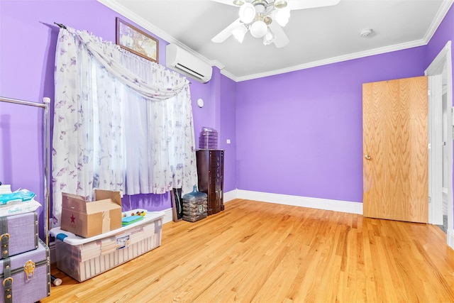 bedroom featuring wood finished floors, crown molding, baseboards, and a wall mounted AC