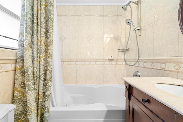 bathroom featuring tile walls, a sink, and shower / bathtub combination with curtain