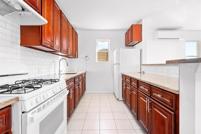 kitchen featuring white appliances, a sink, under cabinet range hood, backsplash, and a wall mounted AC