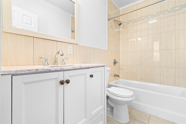 full bath with bathtub / shower combination, toilet, wainscoting, vanity, and tile patterned flooring