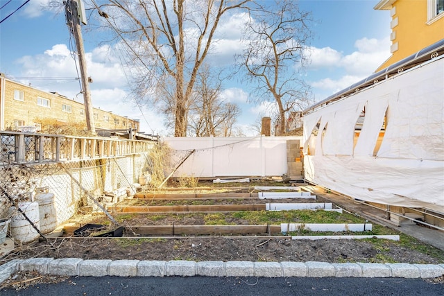 view of yard featuring a fenced backyard and a vegetable garden