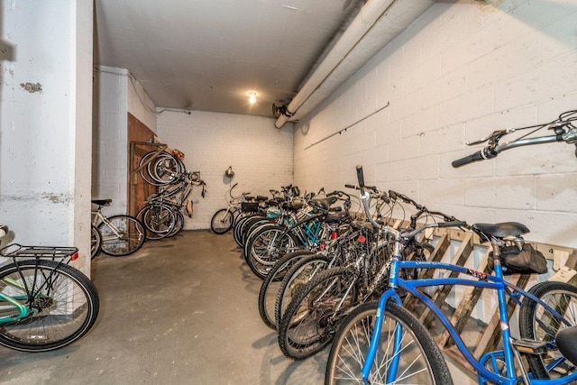 garage featuring concrete block wall and bike storage