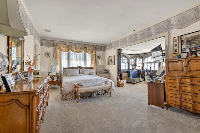 carpeted bedroom featuring visible vents and crown molding