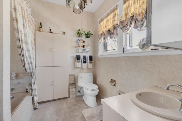 bathroom featuring vanity, shower / bath combination with curtain, and toilet