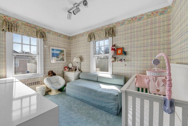 bedroom featuring radiator and wallpapered walls